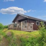 Kingfisher Lodge private decking area with outdoor dining set and scenic views of the Scottish Highlands, Portnellan Estate, Crianlarich.